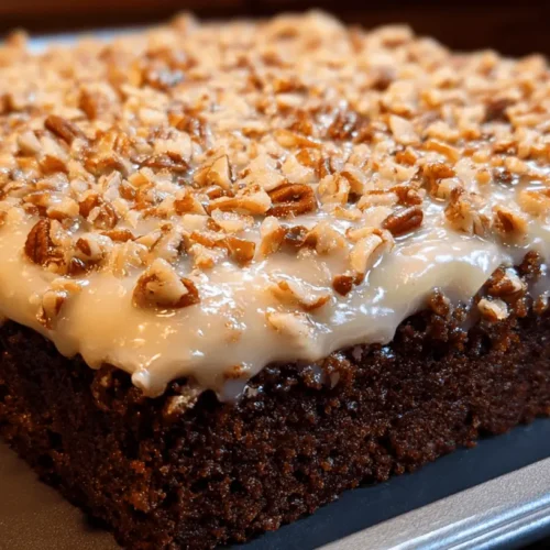 Close-up of a delicious chocolate sheet cake with creamy glaze and chopped pecans in a baking pan.